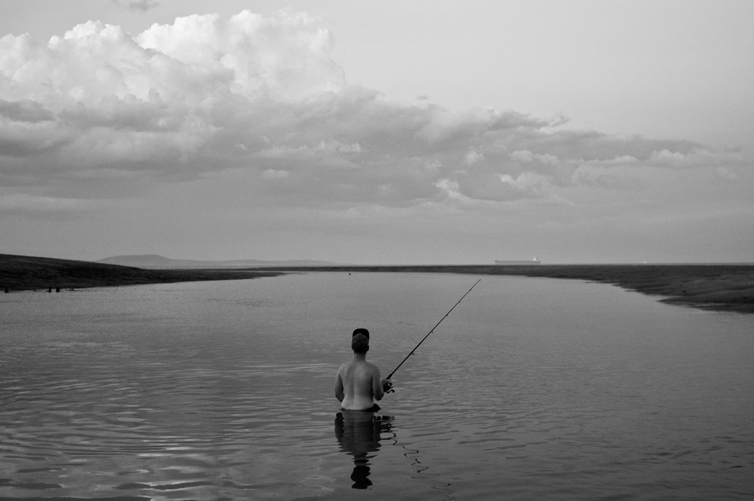 A young boy plays fishing, captured by Mario Zmudzinski.