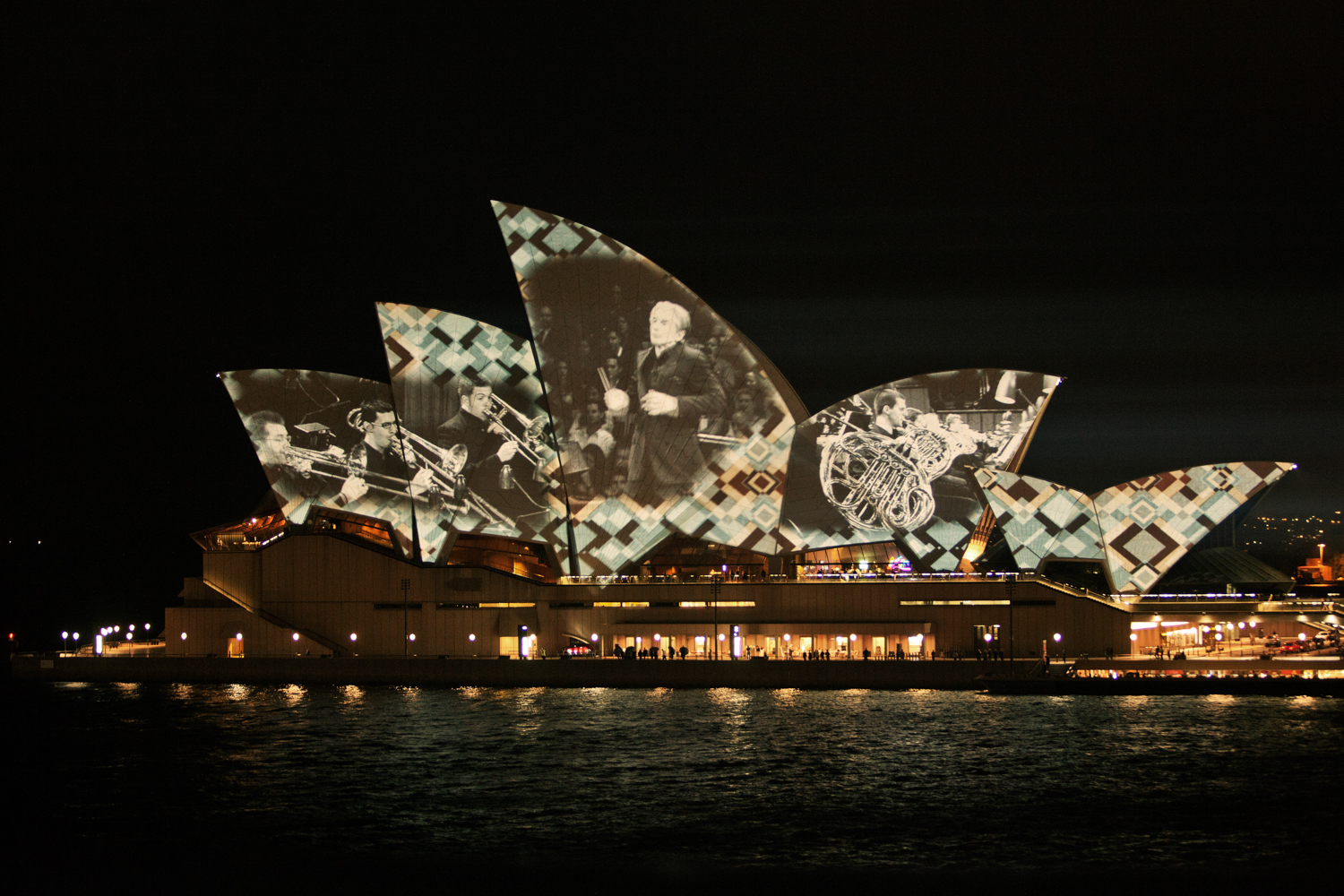 Reflection of the Sydney Opera House on the calm waters of the harbour by Mario Zmudzinski at Magnum Studio