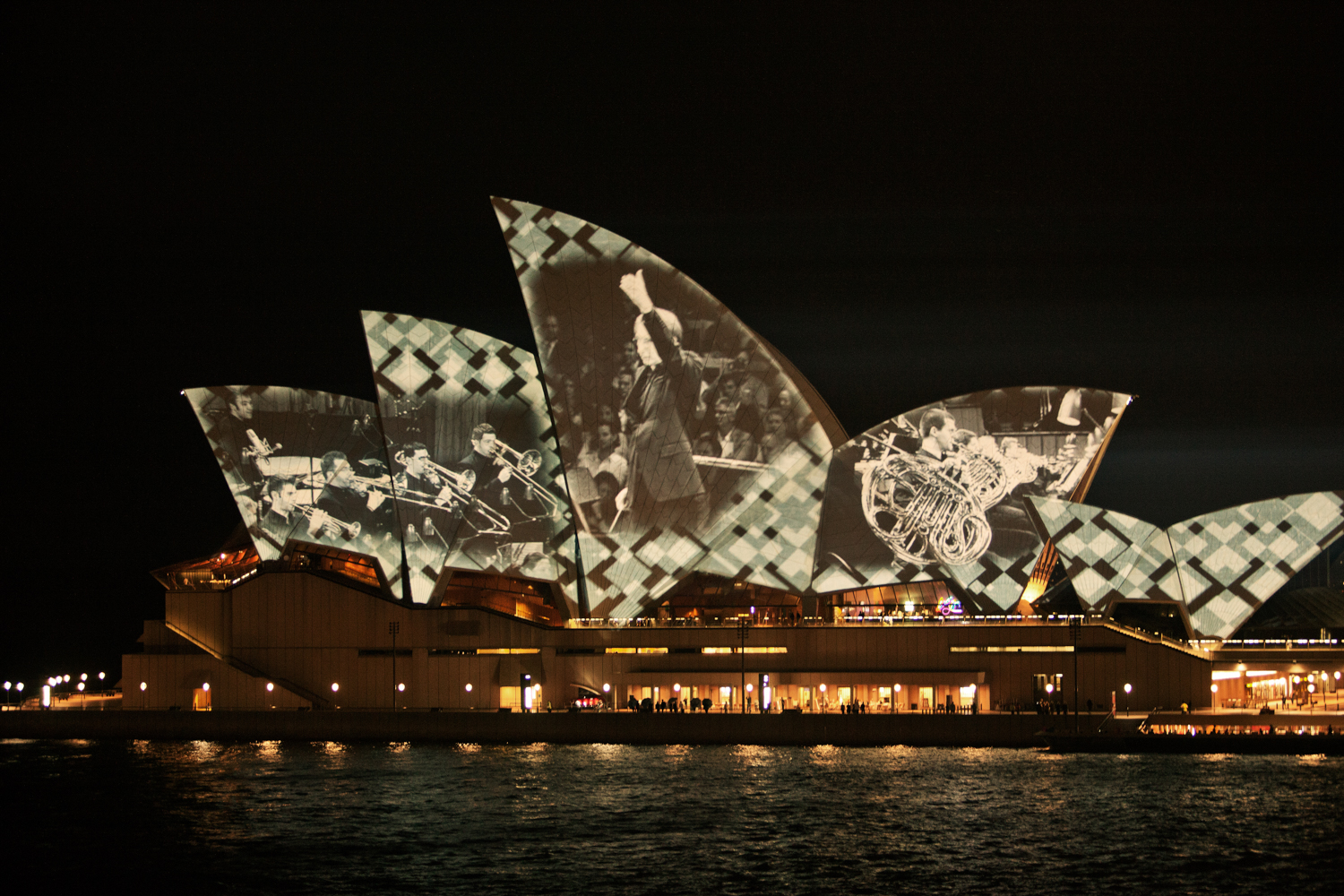 A close-up shot of the Sydney Opera House, with its distinctive roof tiles and sail-like shape. by Mario Zmudzinski at Magnum Studio