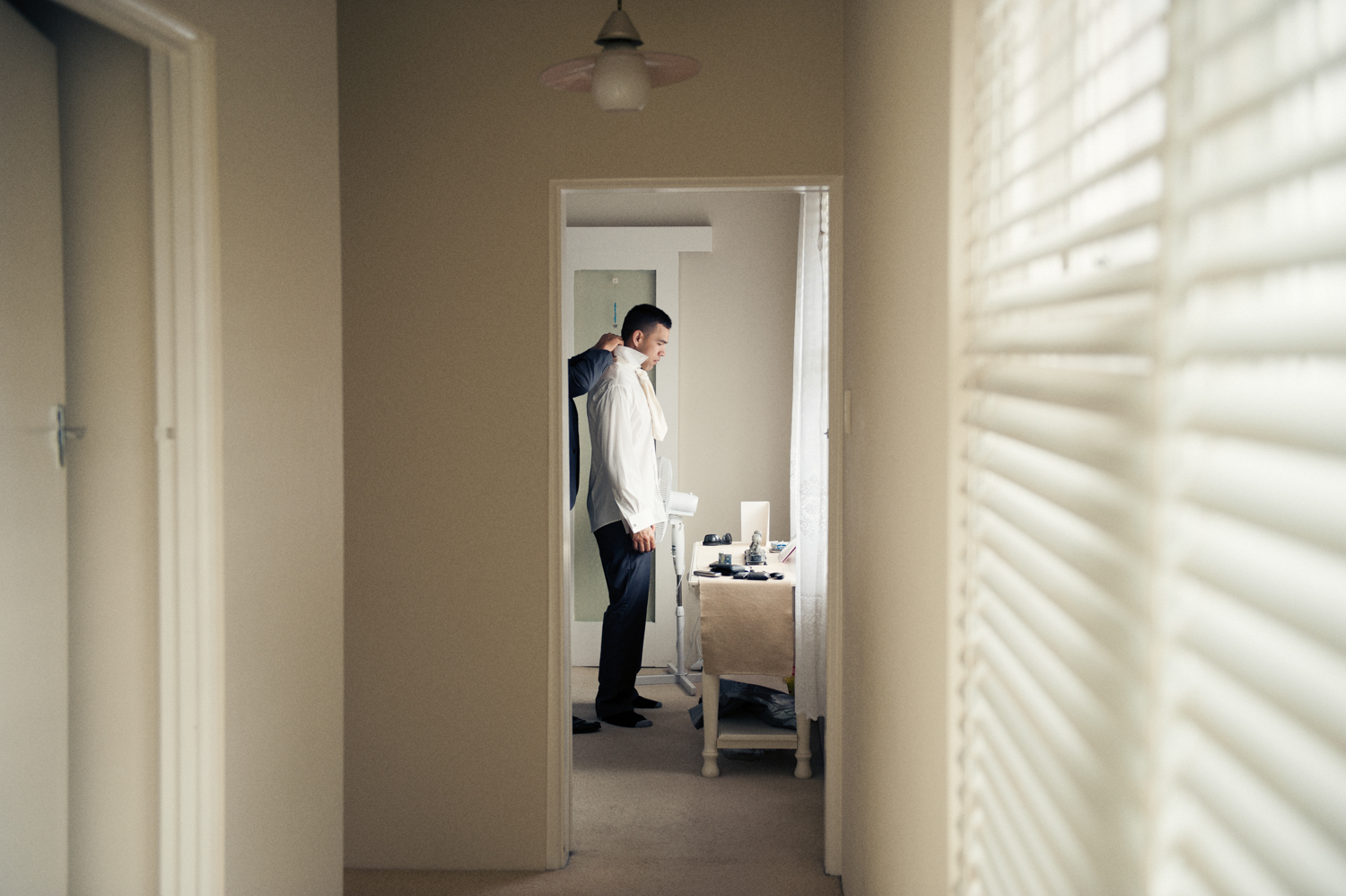 Groomsmen helping the groom prepare for the big day