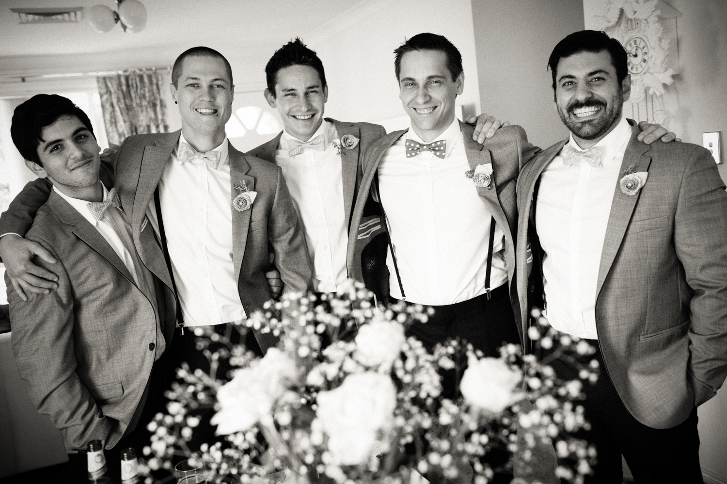 Groom surrounded by family and friends on his wedding day