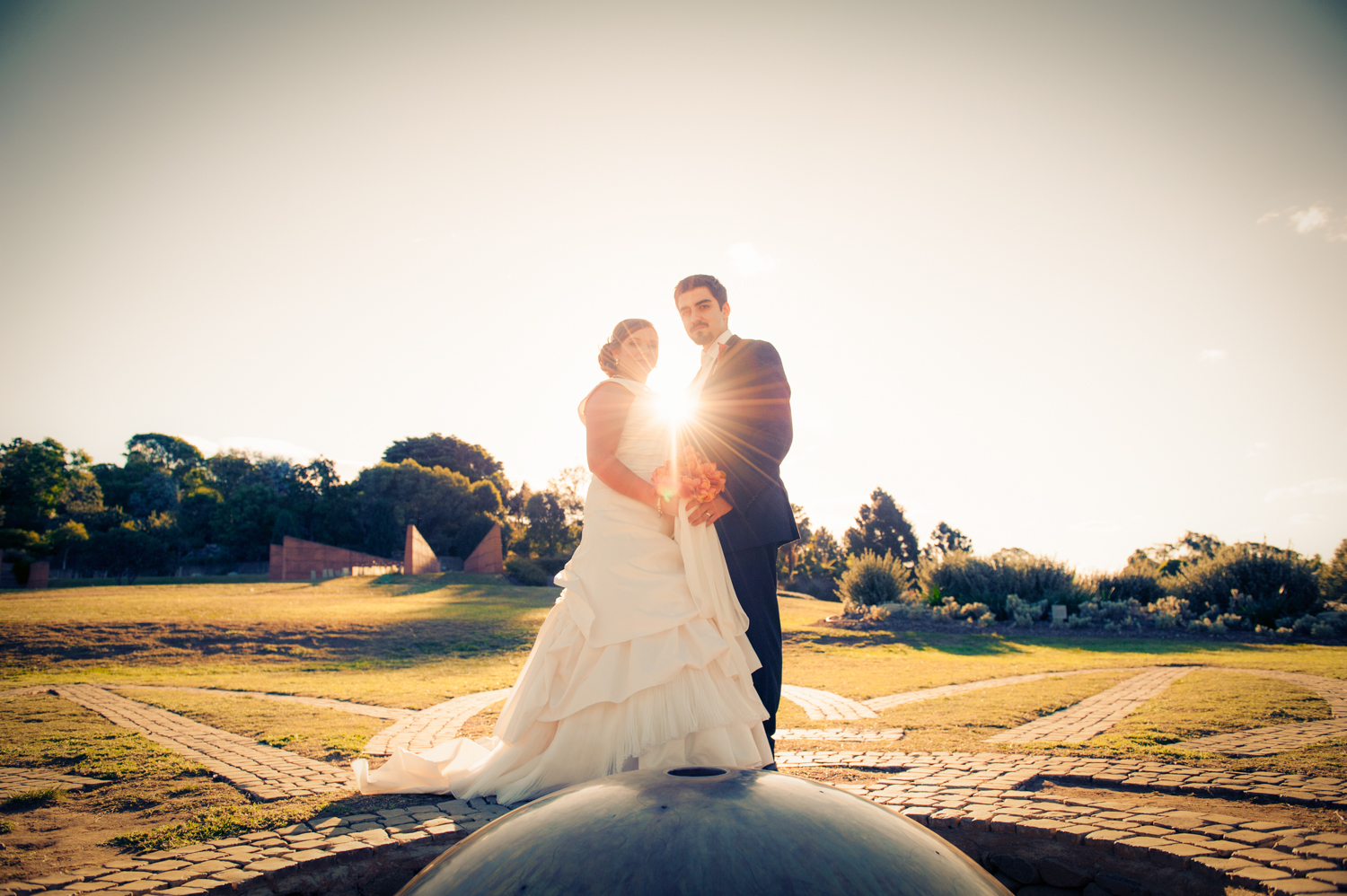 Bride and groom embracing at sunset, photographed by Mario Zmudzinski at Magnum Studio