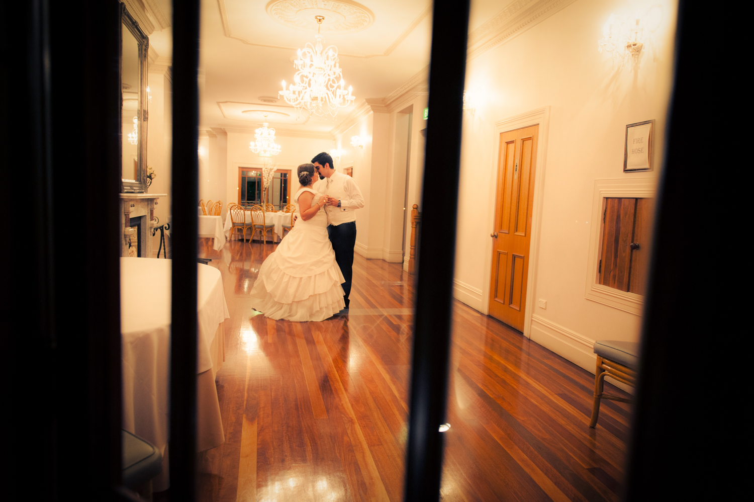 A bride and groom embracing on the dance floor during their wedding reception.