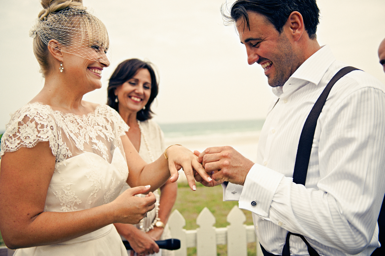 Bride and groom exchange rings during their outdoor wedding ceremony