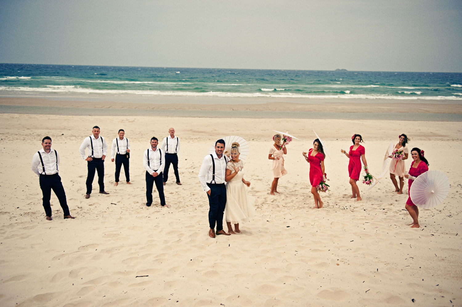 A group of friends celebrating the newlyweds on the beach