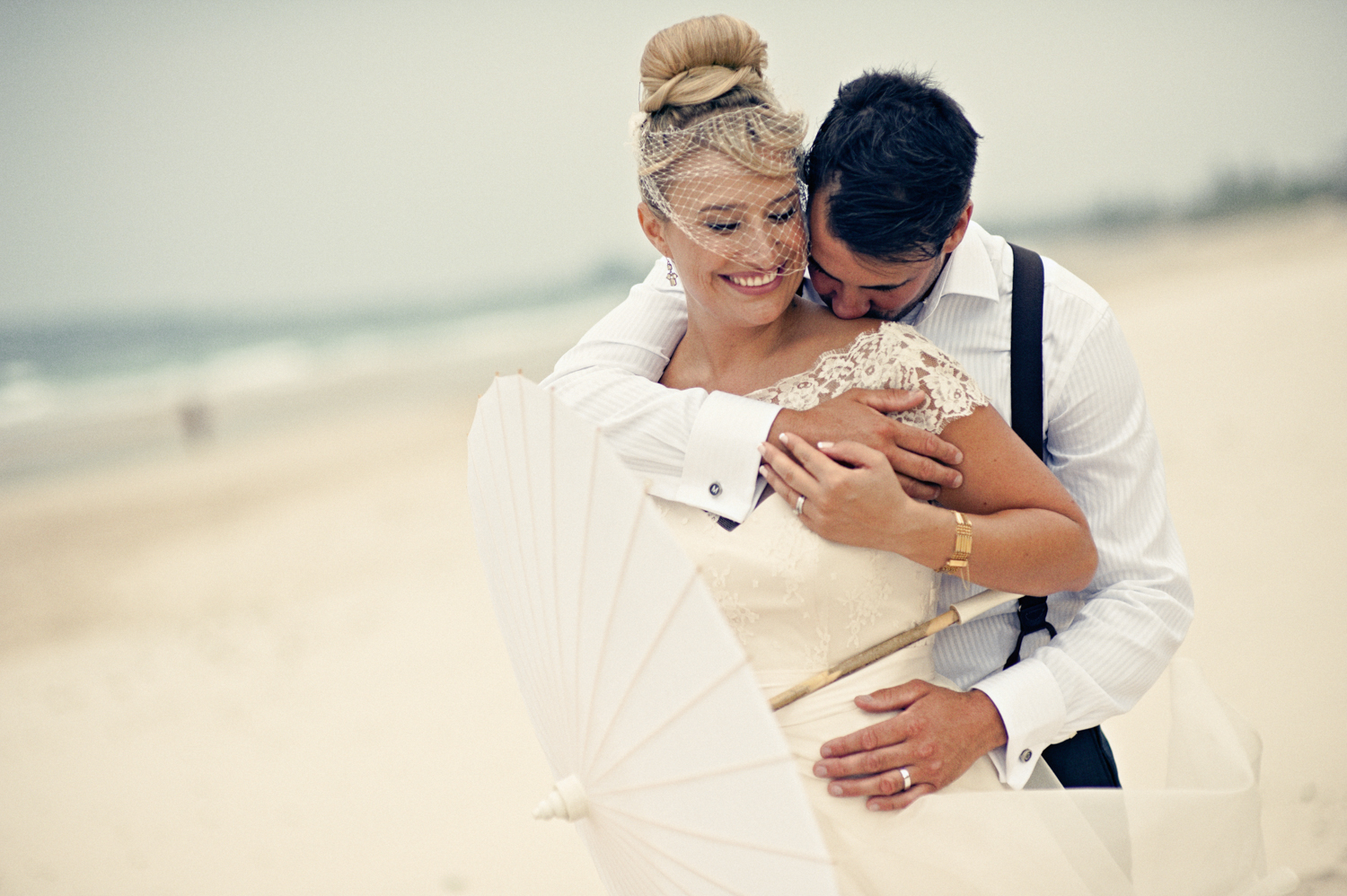 Bride and groom sharing a kiss on the beach
