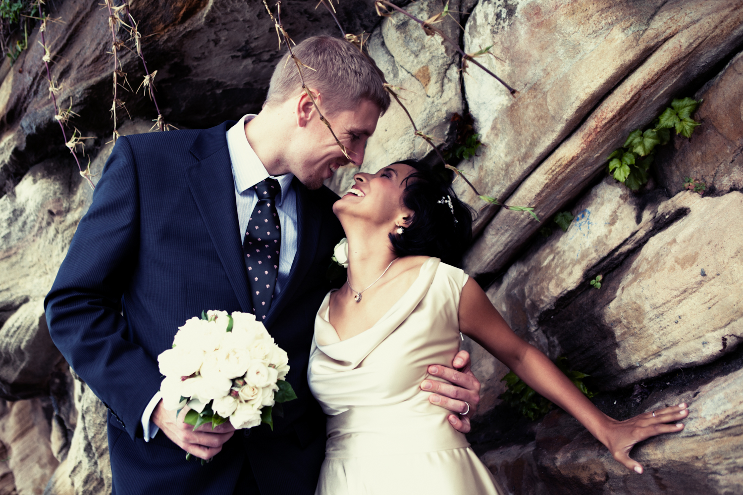 A couple sharing a moment of laughter and joy during their wedding day photo shoot.