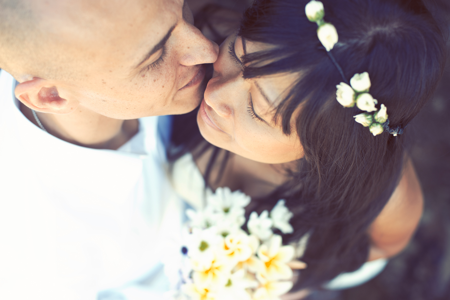 A joyful couple sharing a romantic kiss on their wedding day.